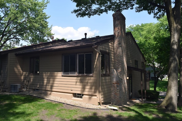 109 Eagle Lake Dr, Maple Grove, MN 55369 - view of side of home with a chimney and a cooling unit