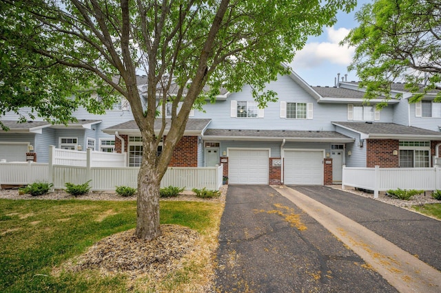 8497 Cortland Rd, Eden Prairie, MN 55344 - multi unit property with driveway, brick siding, and an attached garage