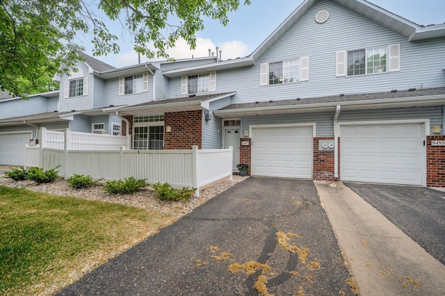 8497 Cortland Rd, Eden Prairie, MN 55344 - multi unit property with brick siding, driveway, and an attached garage