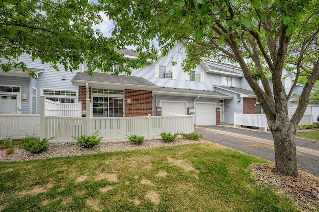 8497 Cortland Rd, Eden Prairie, MN 55344 - multi unit property with driveway, brick siding, and an attached garage