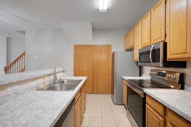 8497 Cortland Rd, Eden Prairie, MN 55344 - kitchen featuring stainless steel appliances, a sink, a textured ceiling, light countertops, and light tile patterned floors