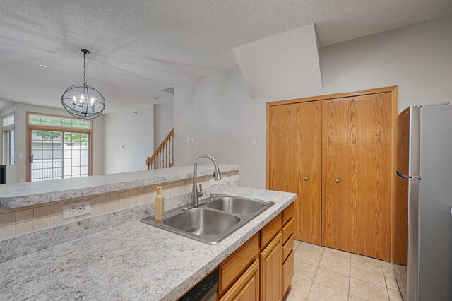 8497 Cortland Rd, Eden Prairie, MN 55344 - kitchen featuring freestanding refrigerator, a sink, light countertops, a chandelier, and decorative light fixtures