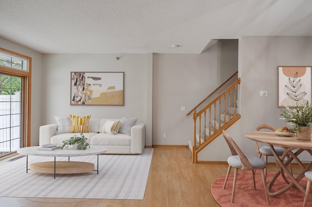 8497 Cortland Rd, Eden Prairie, MN 55344 - living room featuring stairs, wood finished floors, a textured ceiling, and baseboards