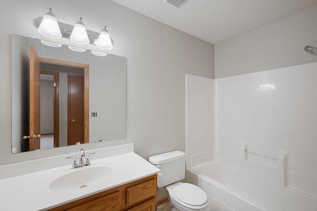 8497 Cortland Rd, Eden Prairie, MN 55344 - bathroom with vanity, toilet, a textured ceiling, and shower / tub combination