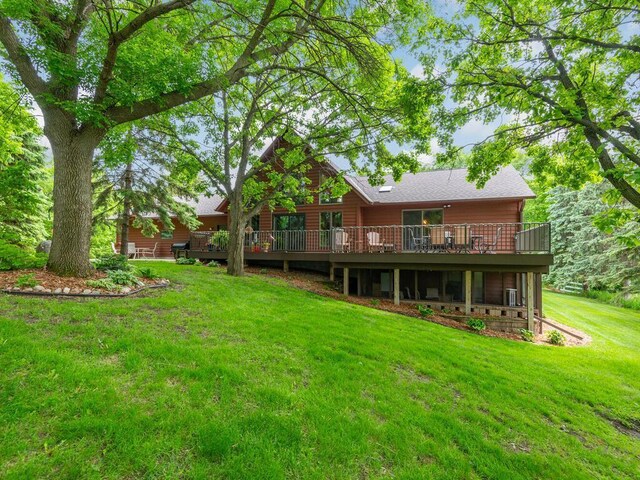 71156 Csah 18, Collinwood Twp, MN 55325 - rear view of property featuring a wooden deck, a yard, and roof with shingles