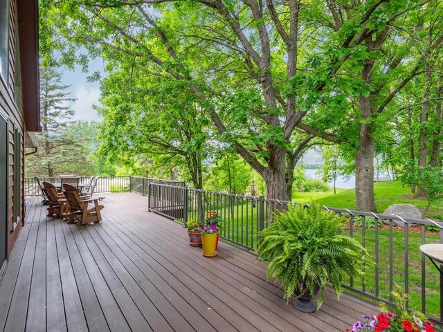 71156 Csah 18, Collinwood Twp, MN 55325 - wooden deck featuring outdoor dining space, a yard, and a water view