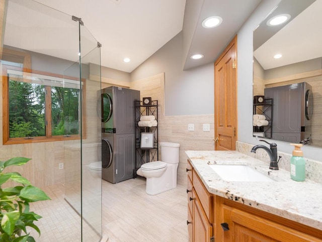 71156 Csah 18, Collinwood Twp, MN 55325 - full bath featuring stacked washing machine and dryer, toilet, vanity, tile walls, and walk in shower