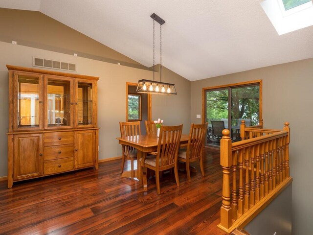 71156 Csah 18, Collinwood Twp, MN 55325 - dining space with lofted ceiling, dark wood-type flooring, a skylight, a chandelier, and baseboards