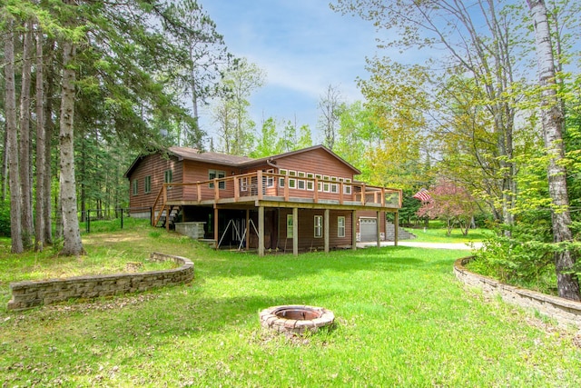 51850 Scenic Hwy Unit 7, Bigfork, MN 56628 - back of property with a fire pit, a wooden deck, a lawn, and an attached garage