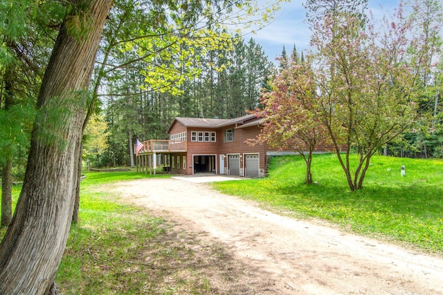 51850 Scenic Hwy Unit 7, Bigfork, MN 56628 - view of front of property featuring driveway, an attached garage, a wooden deck, and a front yard
