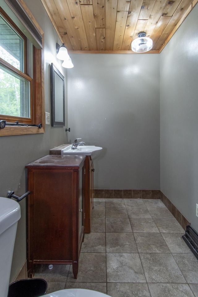 51850 Scenic Hwy Unit 7, Bigfork, MN 56628 - bathroom featuring wood ceiling, toilet, vanity, and baseboards