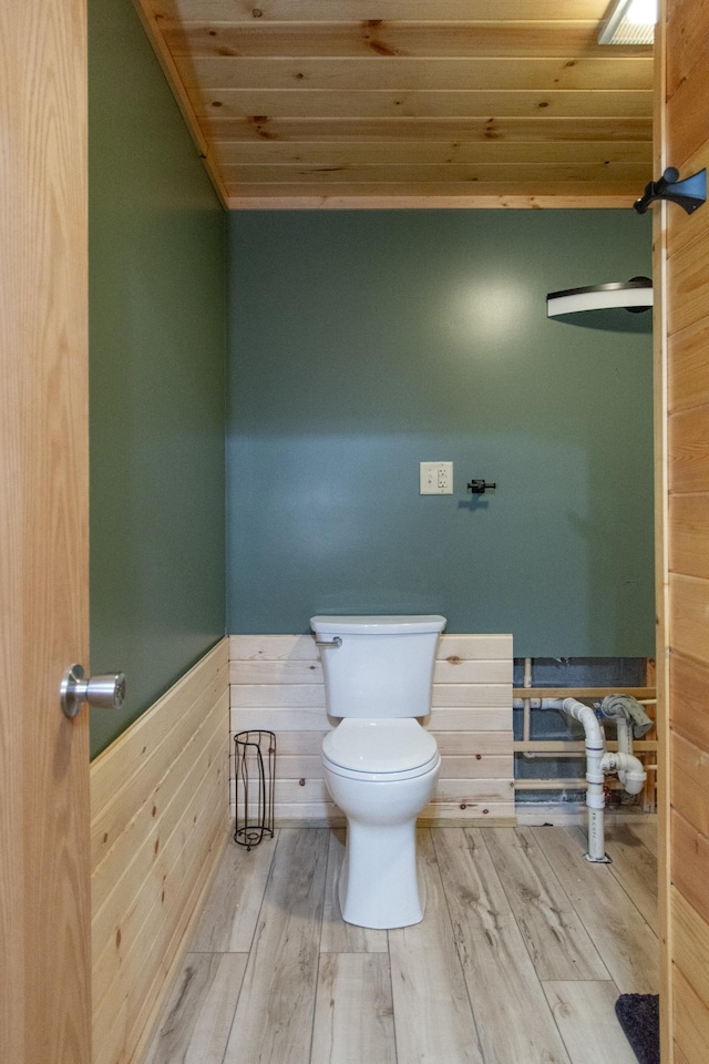 51850 Scenic Hwy Unit 7, Bigfork, MN 56628 - bathroom with toilet, wooden ceiling, wood finished floors, a wainscoted wall, and wood walls