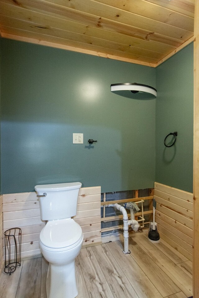 51850 Scenic Hwy Unit 7, Bigfork, MN 56628 - bathroom with wood ceiling, wainscoting, toilet, wood finished floors, and wood walls