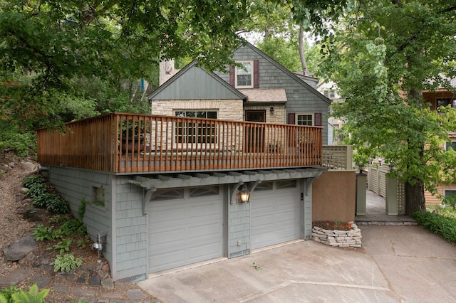 1112 Vincent Ave S, Minneapolis, MN 55405 - back of house with stone siding, a chimney, driveway, a balcony, and an attached garage