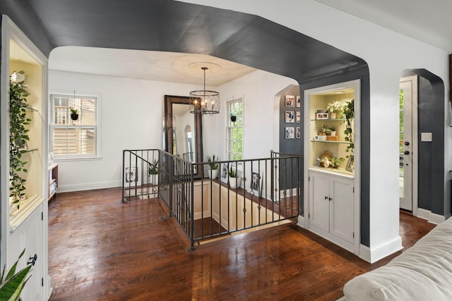1112 Vincent Ave S, Minneapolis, MN 55405 - foyer featuring a chandelier, dark wood-style floors, arched walkways, and baseboards