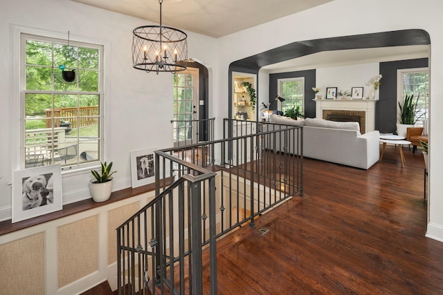 1112 Vincent Ave S, Minneapolis, MN 55405 - stairs with wood finished floors, a chandelier, healthy amount of natural light, and baseboards