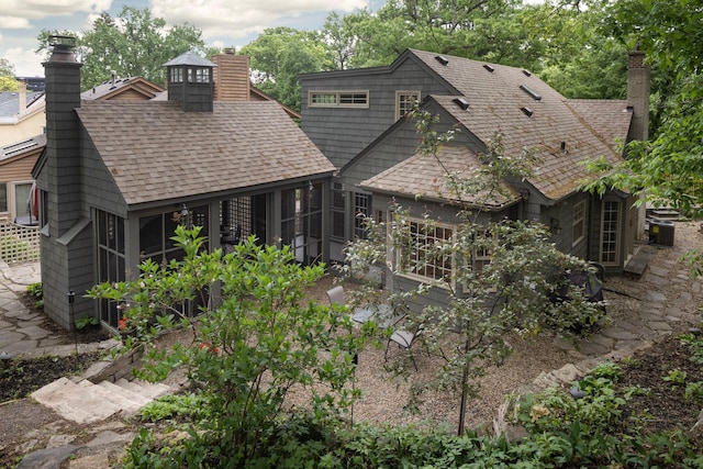 1112 Vincent Ave S, Minneapolis, MN 55405 - rear view of property featuring a sunroom, a chimney, and roof with shingles