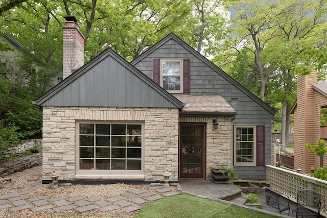 1112 Vincent Ave S, Minneapolis, MN 55405 - view of front of property with stone siding, roof with shingles, and board and batten siding