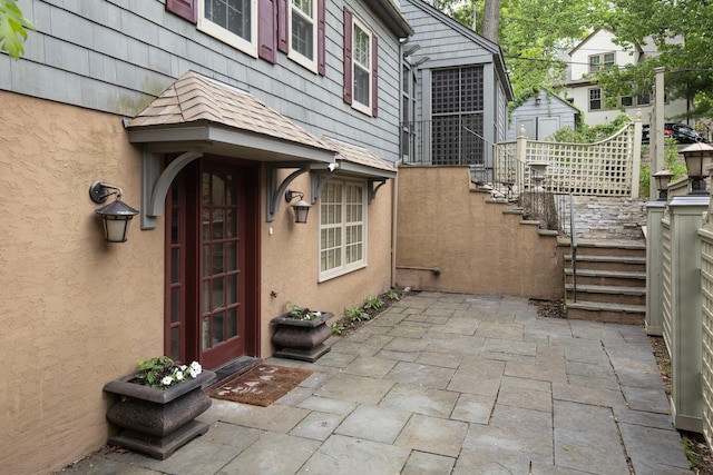 1112 Vincent Ave S, Minneapolis, MN 55405 - doorway to property with stucco siding and a patio area