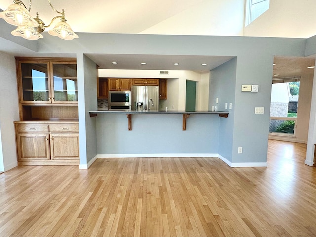 1976 Bay St, Worthington, MN 56187 - kitchen with stainless steel appliances, light wood-style floors, a chandelier, and recessed lighting