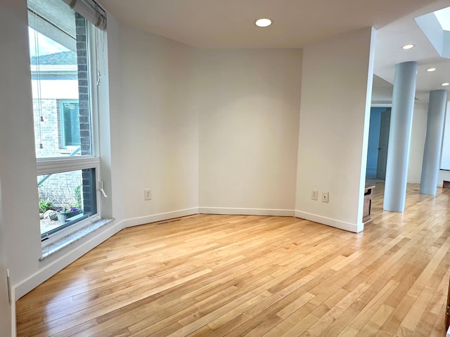 1976 Bay St, Worthington, MN 56187 - empty room with light wood-style flooring, a skylight, baseboards, and recessed lighting