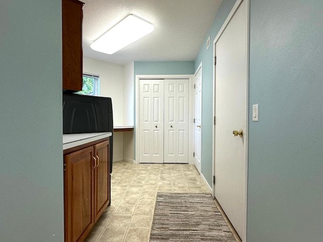 1976 Bay St, Worthington, MN 56187 - corridor with light tile patterned floors and a textured ceiling
