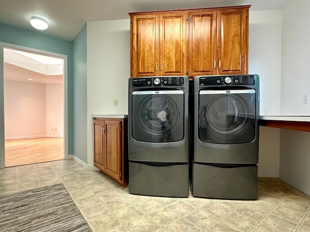 1976 Bay St, Worthington, MN 56187 - laundry room with washing machine and clothes dryer, a skylight, cabinet space, and light tile patterned floors