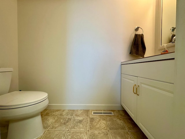 1976 Bay St, Worthington, MN 56187 - half bath with toilet, baseboards, vanity, and tile patterned floors