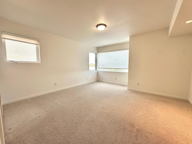 1976 Bay St, Worthington, MN 56187 - unfurnished room with baseboards, carpet, and a textured ceiling