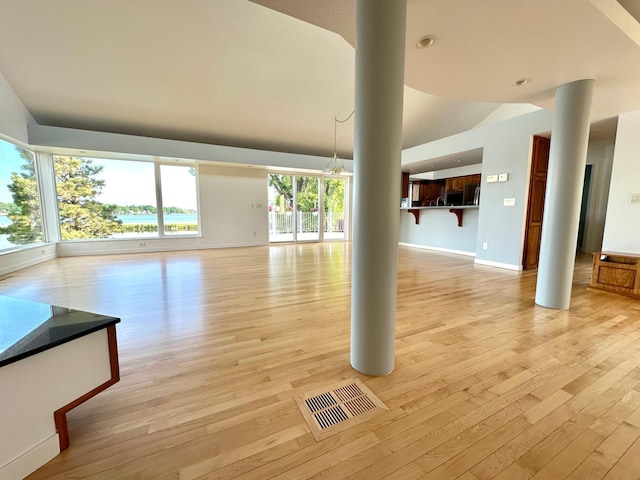 1976 Bay St, Worthington, MN 56187 - unfurnished living room with light wood-type flooring, baseboards, recessed lighting, and decorative columns
