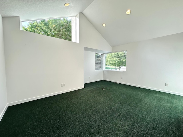 1976 Bay St, Worthington, MN 56187 - empty room featuring dark carpet, baseboards, high vaulted ceiling, and recessed lighting