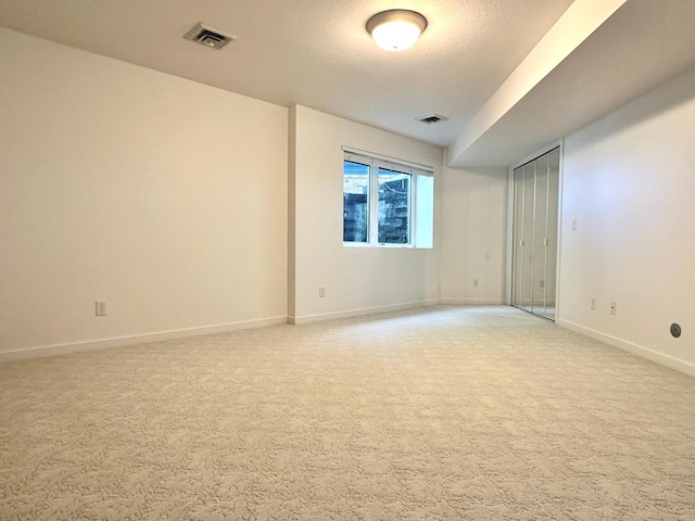 1976 Bay St, Worthington, MN 56187 - unfurnished room with light colored carpet, baseboards, and a textured ceiling
