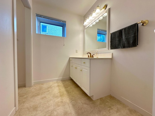 1976 Bay St, Worthington, MN 56187 - bathroom with vanity, tile patterned flooring, and baseboards