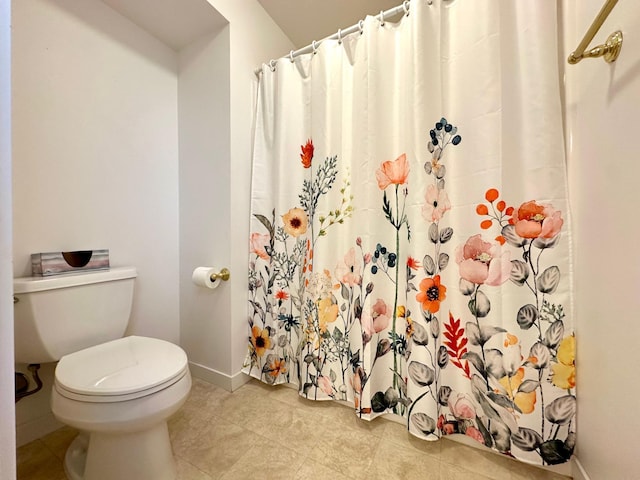 1976 Bay St, Worthington, MN 56187 - bathroom with toilet, baseboards, curtained shower, and tile patterned flooring