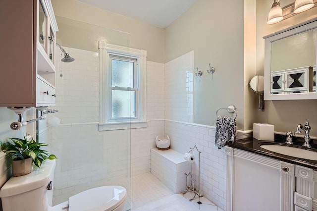 bathroom featuring toilet, walk in shower, vanity, and tile patterned flooring