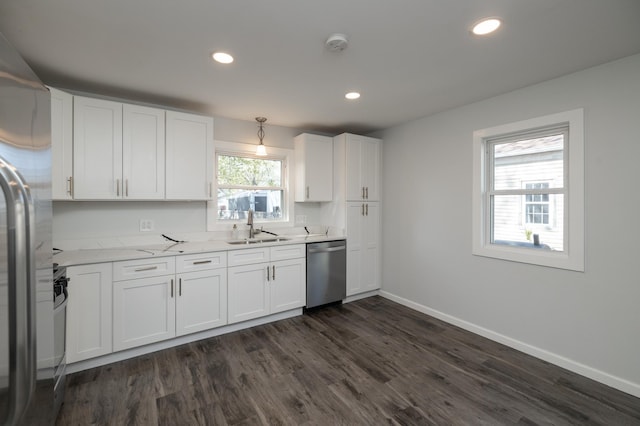 kitchen with stainless steel appliances, a sink, dark wood-style floors, white cabinets, and recessed lighting