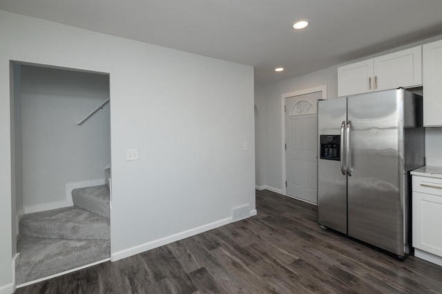 kitchen with stainless steel fridge with ice dispenser, dark wood-style floors, white cabinetry, recessed lighting, and baseboards