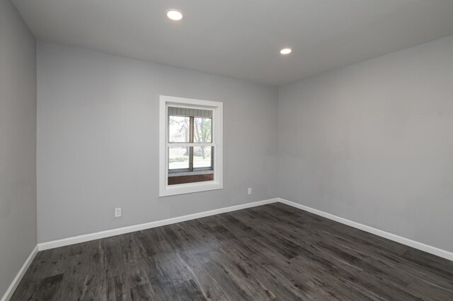 unfurnished room with dark wood finished floors, baseboards, and recessed lighting