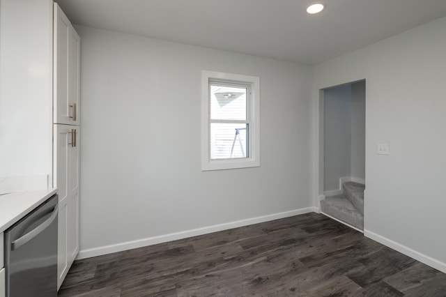 unfurnished dining area featuring dark wood-style floors, baseboards, stairway, and recessed lighting