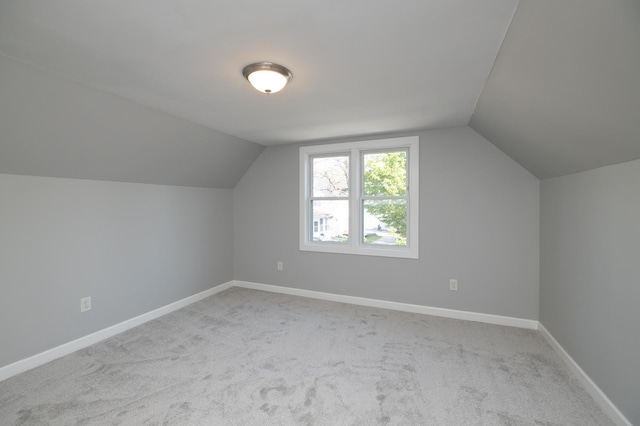additional living space with lofted ceiling, carpet flooring, and baseboards
