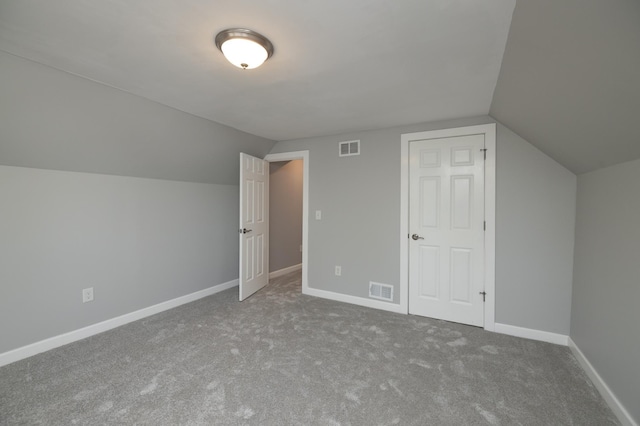 additional living space featuring vaulted ceiling, carpet floors, and baseboards