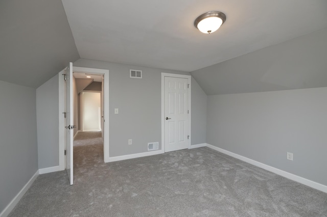 bonus room with lofted ceiling, carpet floors, and baseboards