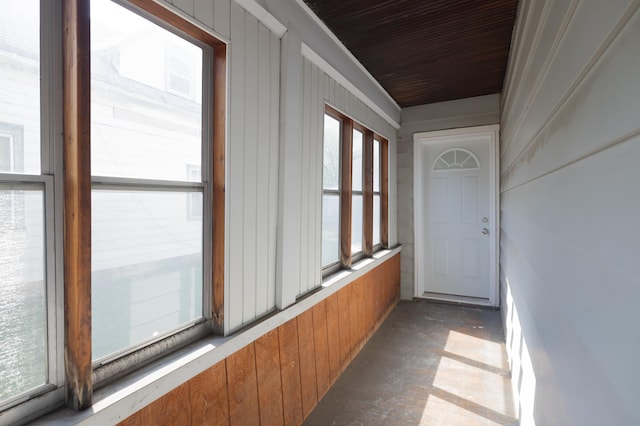 hall with healthy amount of natural light and wooden ceiling