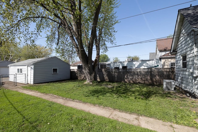 view of yard featuring central air condition unit and an outdoor structure