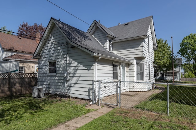 view of side of home featuring a gate, central AC, and a shingled roof
