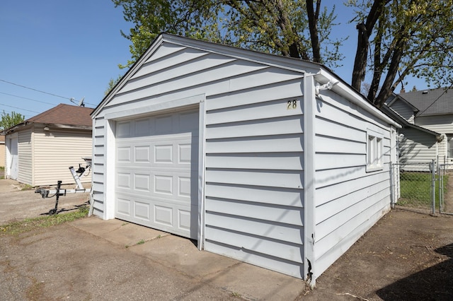 detached garage featuring fence