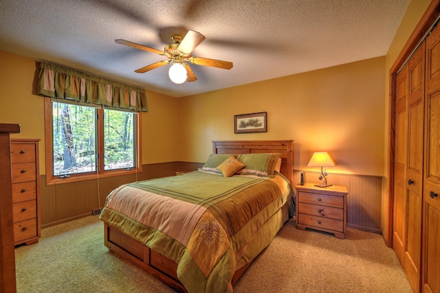 27166 Hersant Rd, Meenon Twp, WI 54893 - bedroom with a wainscoted wall, a closet, light carpet, a textured ceiling, and wooden walls