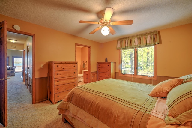 27166 Hersant Rd, Meenon Twp, WI 54893 - bedroom featuring a wainscoted wall, light colored carpet, wooden walls, a textured ceiling, and ensuite bathroom