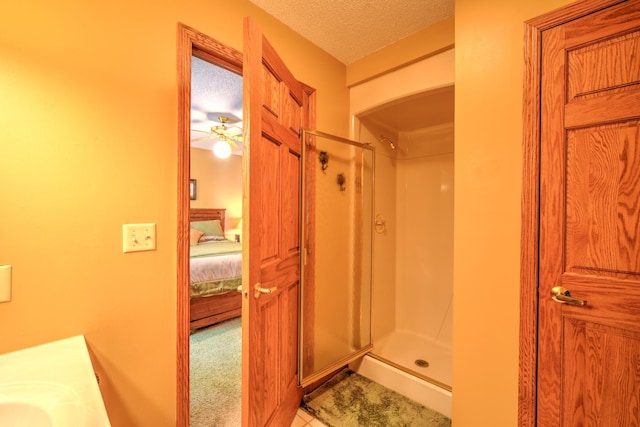 27166 Hersant Rd, Meenon Twp, WI 54893 - full bathroom with a shower stall, ensuite bathroom, tile patterned floors, vanity, and a textured ceiling