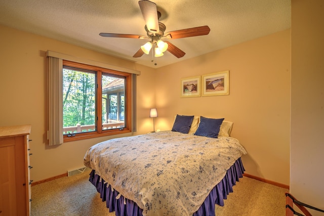 27166 Hersant Rd, Meenon Twp, WI 54893 - bedroom featuring light colored carpet, baseboards, a textured ceiling, and a ceiling fan